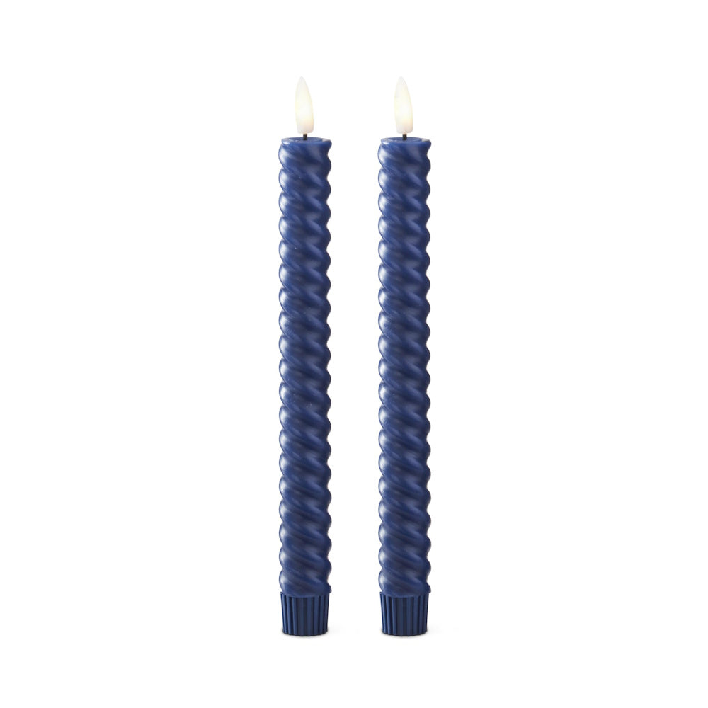 Two dark blue spiral taper candles with glowing, flame-shaped LED tips standing against a white background.