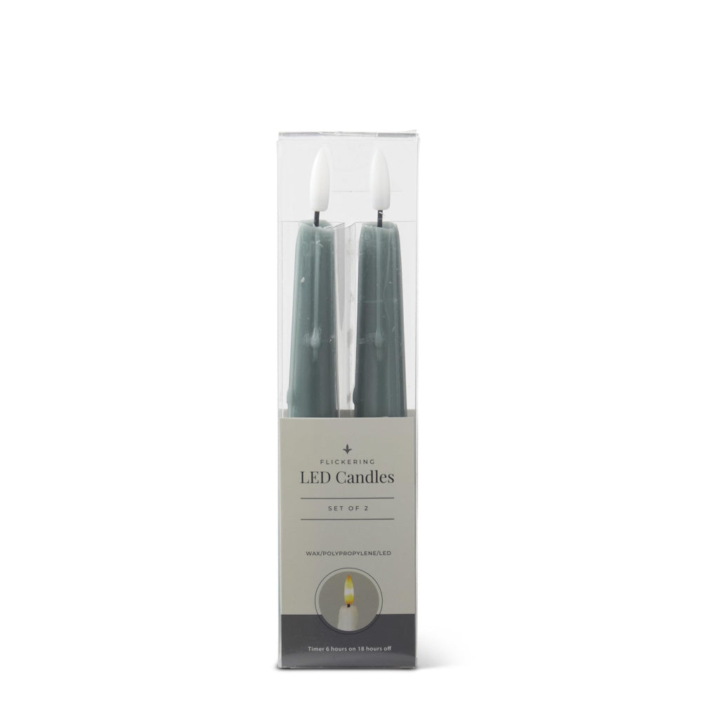 Set of 2 dark green flickering LED taper candles packaged in a clear plastic box against a white background.