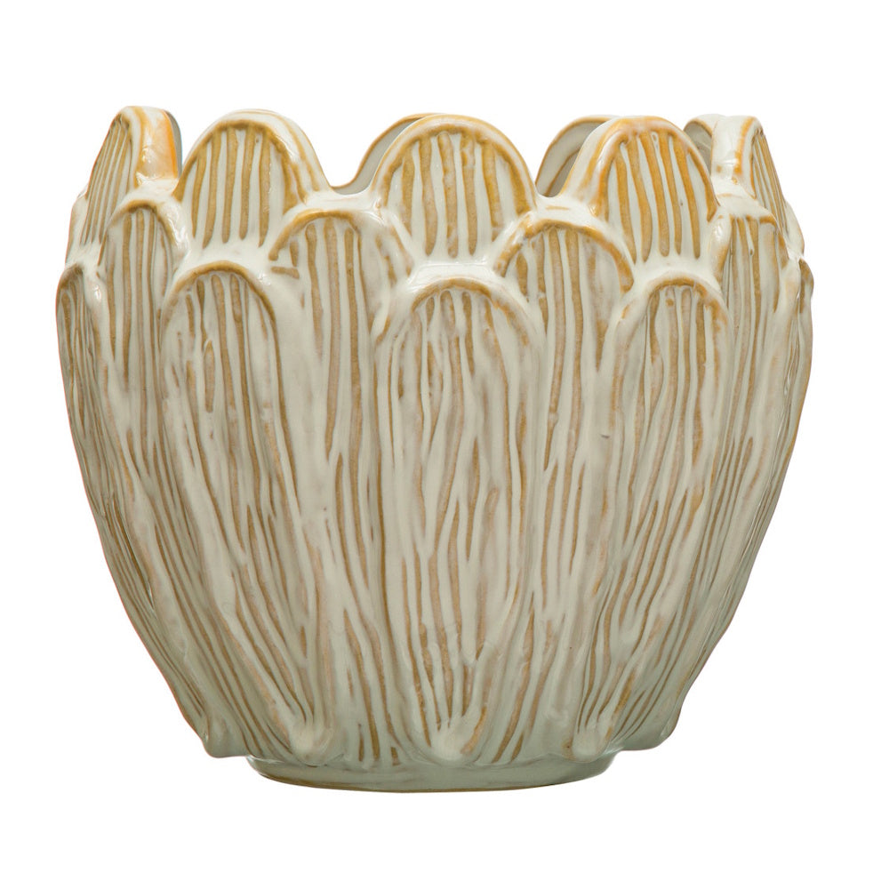 Cream ceramic flower-shaped planter pot with debossed vertical petal textures and tan rim accents.