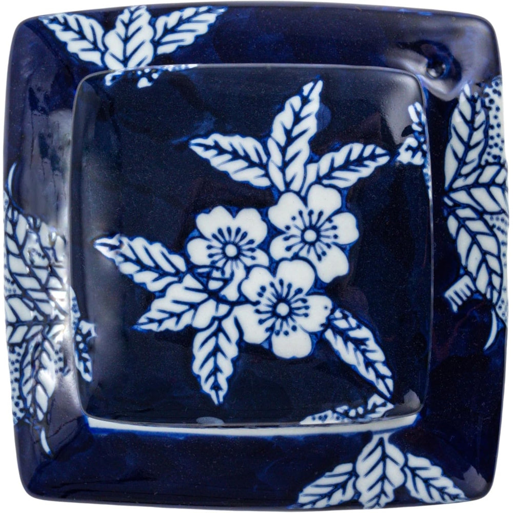 Top view of a square blue and white ceramic ginger jar lid featuring a hand-painted floral pattern.