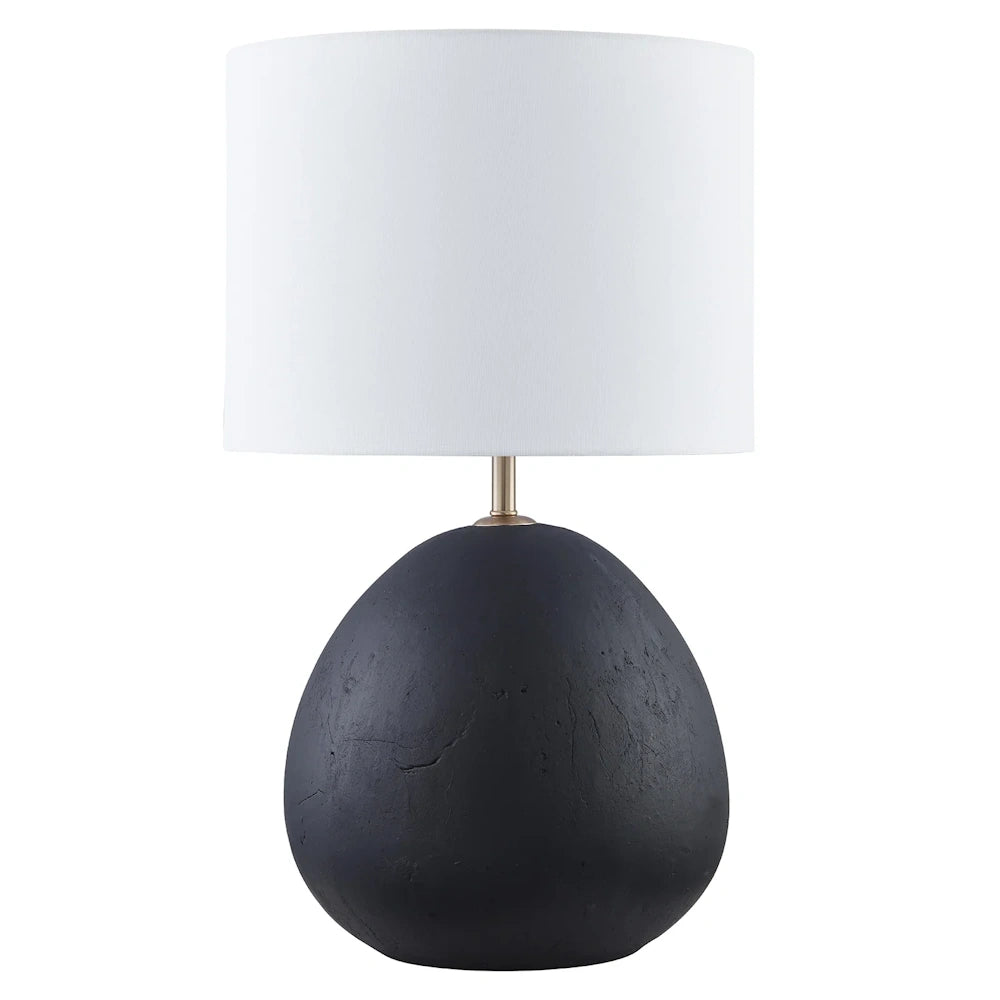 Modern black ceramic table lamp with a textured pebble base and a crisp white drum fabric shade.