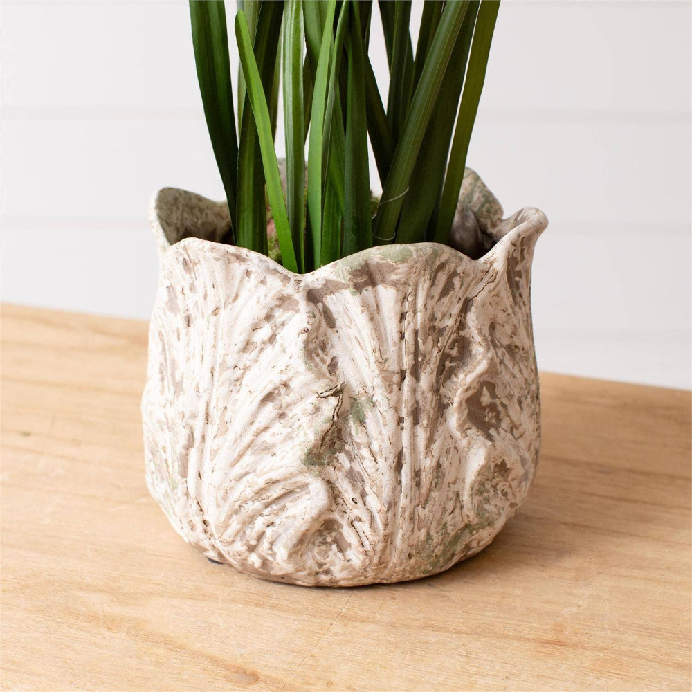 Rustic white leaf design planter with a distressed finish and green foliage on a wooden surface for farmhouse home decor.