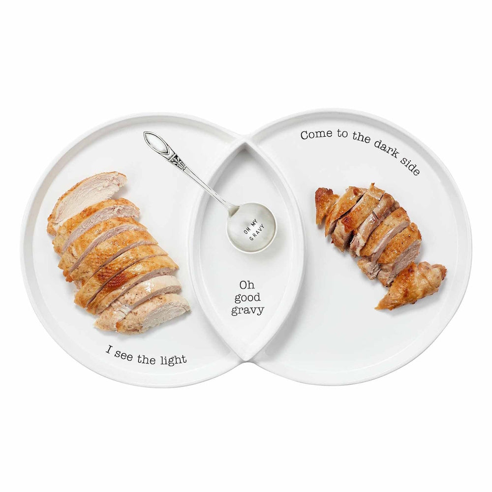 Divided white ceramic turkey serving platter with light and dark meat sections and a gravy spoon.