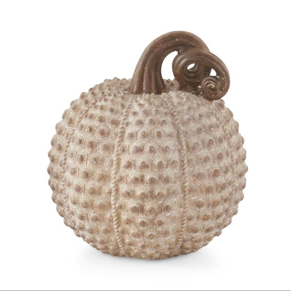 Textured beige resin pumpkin with a dotted pattern and a curled brown stem.