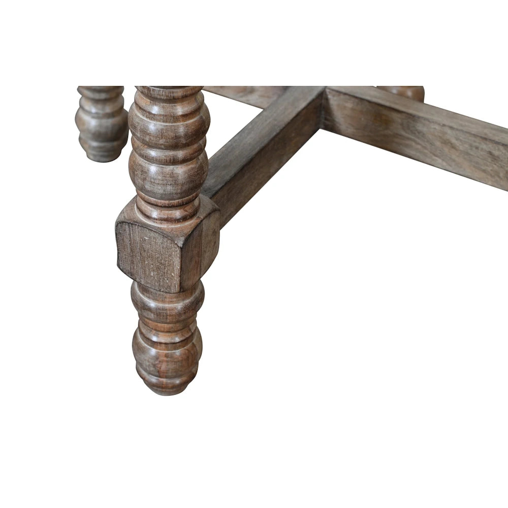 Close up of natural wood accent table turned spindle leg and cross stretcher base construction.