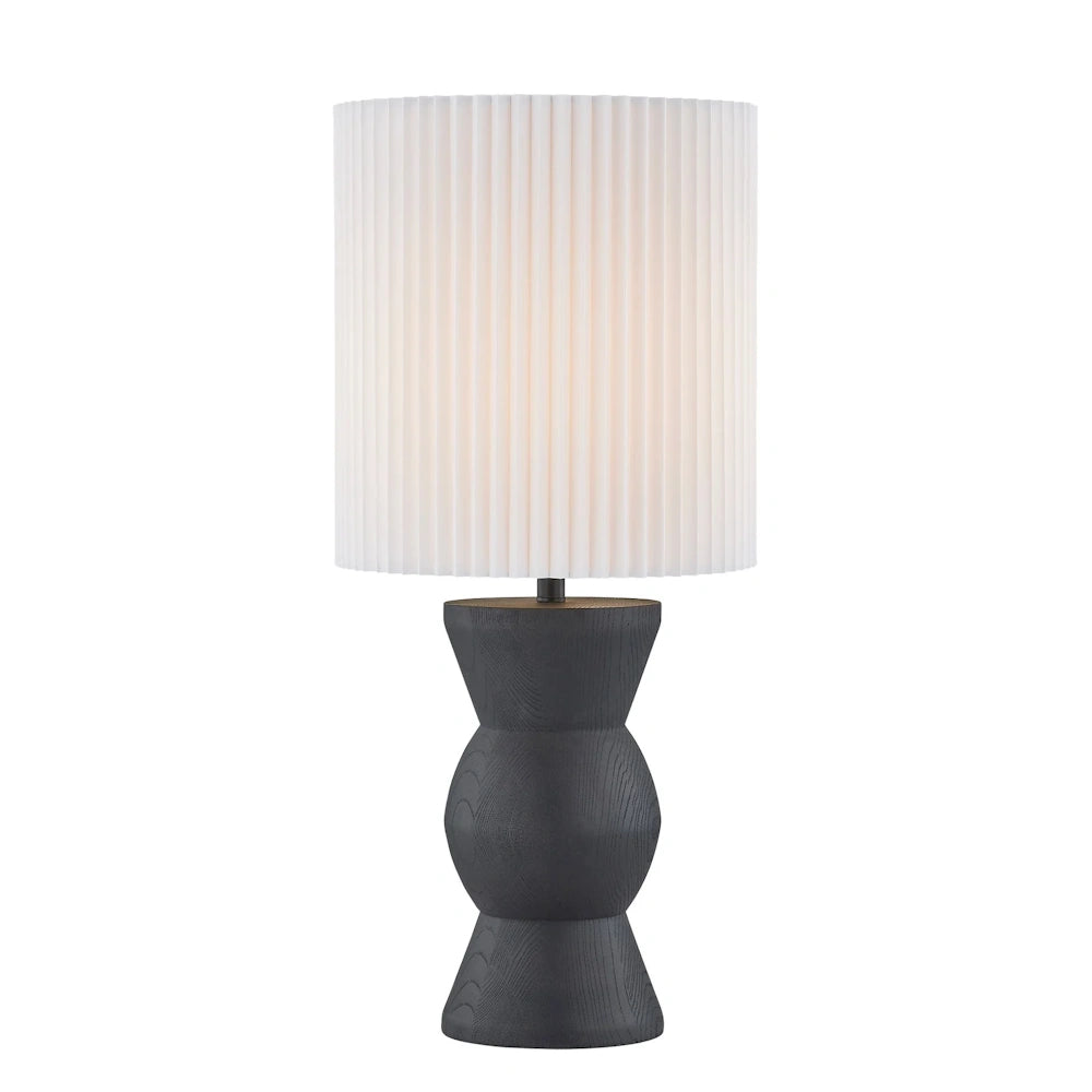 Black sculptural table lamp with white pleated shade and textured hourglass base for modern decor.