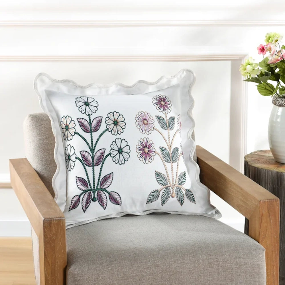 Tamara Day floral embroidered pillow with scalloped edges on a grey armchair, lifestyle home decor with flower vase.