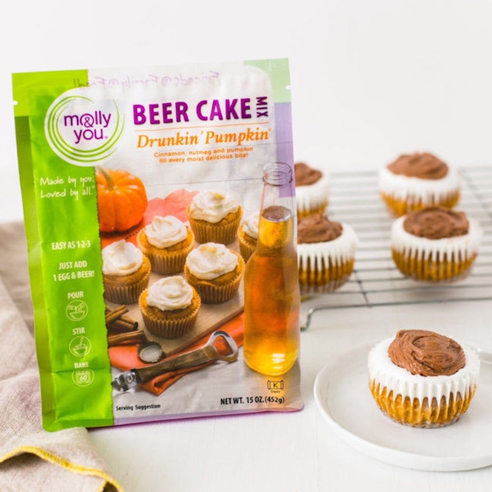 Molly & You Drunkin’ Pumpkin Beer Cake Mix bag standing next to freshly baked iced cupcakes.