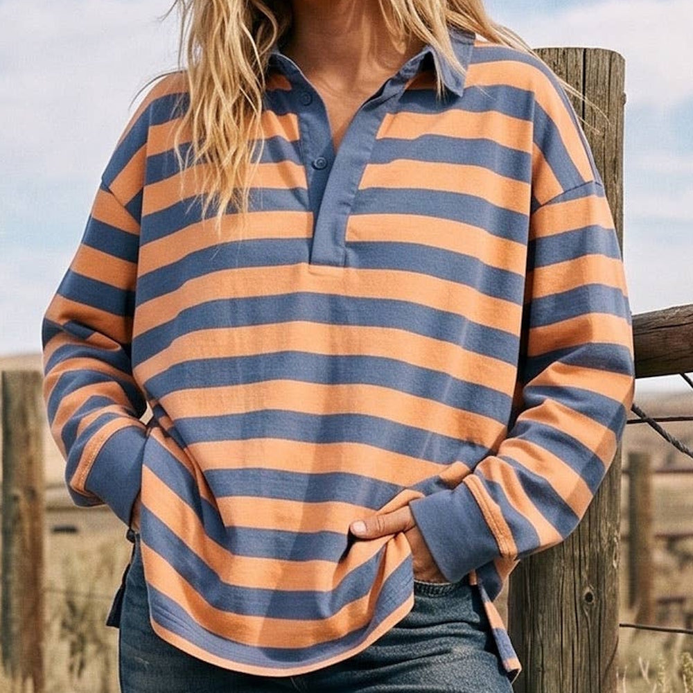 Person wearing an oversized, long-sleeve rugby polo shirt with blue and orange horizontal stripes.