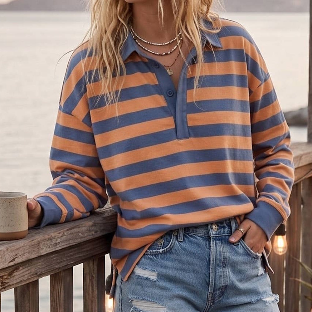 Oversized long-sleeve rugby polo shirt with blue and orange horizontal stripes, styled with distressed denim.