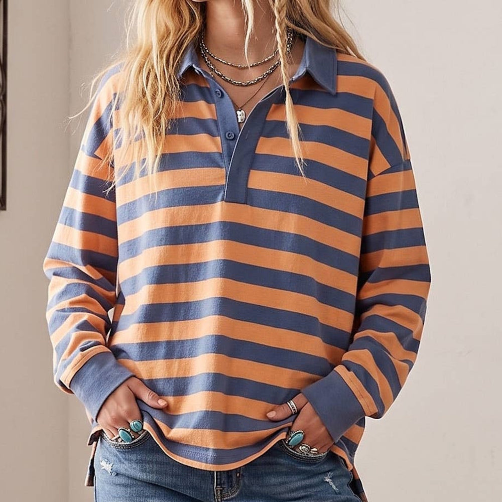 Woman wearing an oversized long-sleeve rugby polo shirt with blue and orange horizontal stripes.