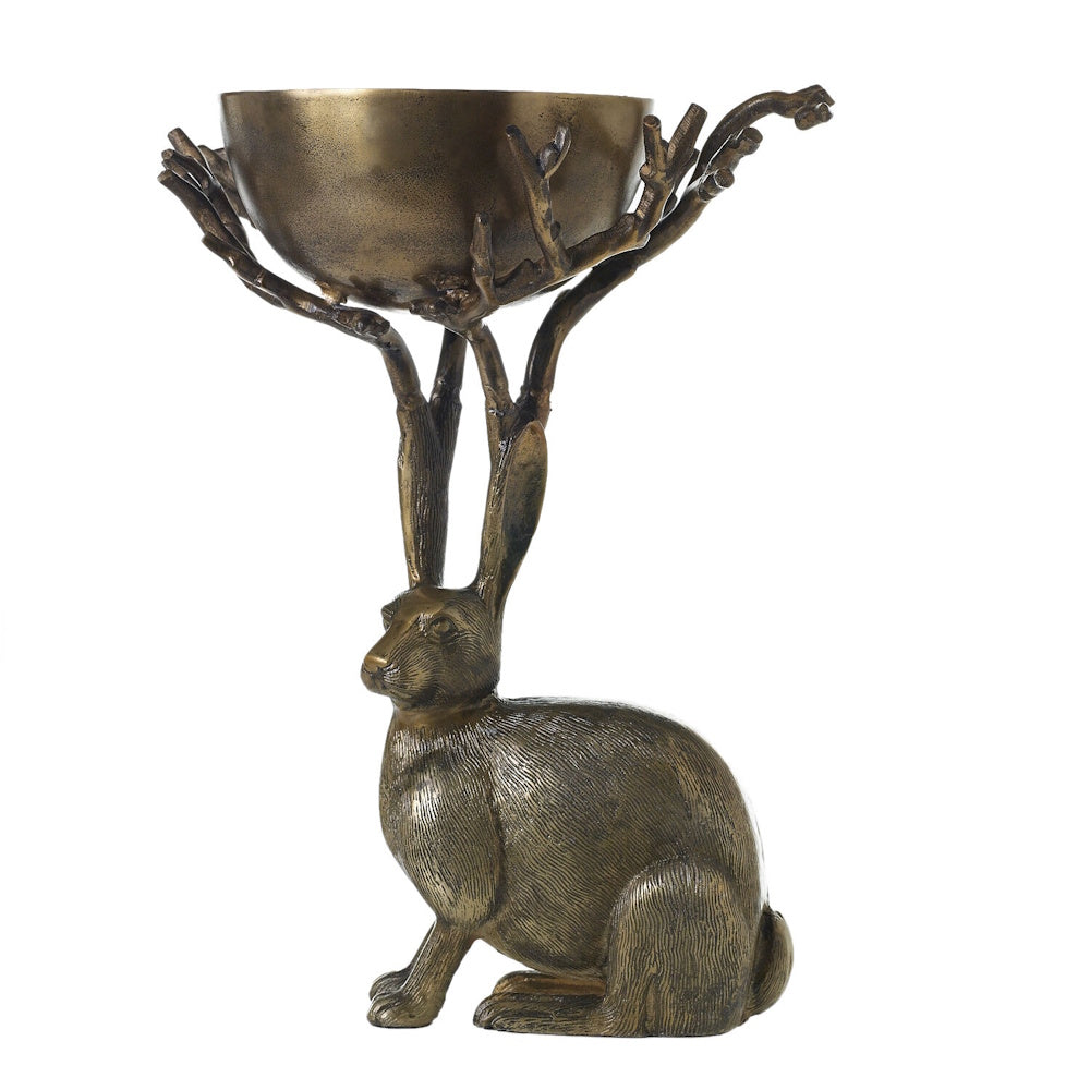 Side view of an antique gold resin rabbit holding up a branch-supported bowl.