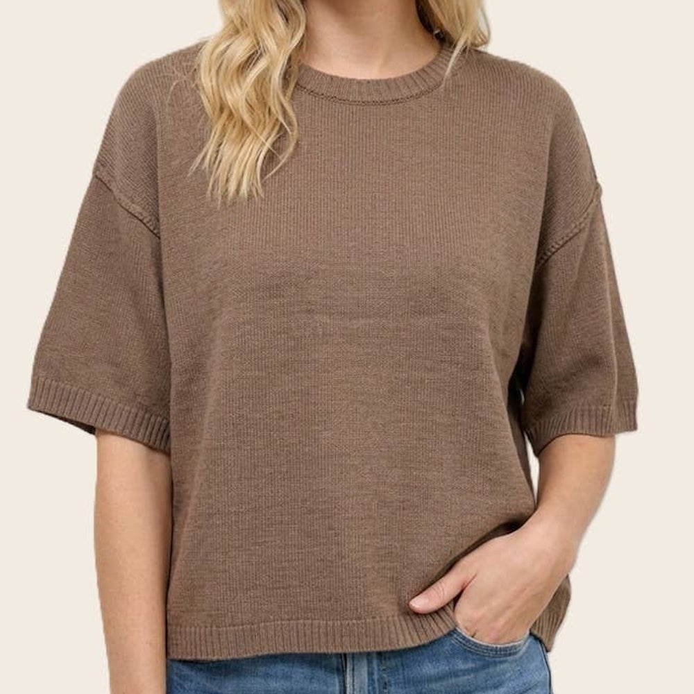 Front view of a mocha brown short-sleeve knit sweater with a crew neckline and ribbed trim worn by a model.