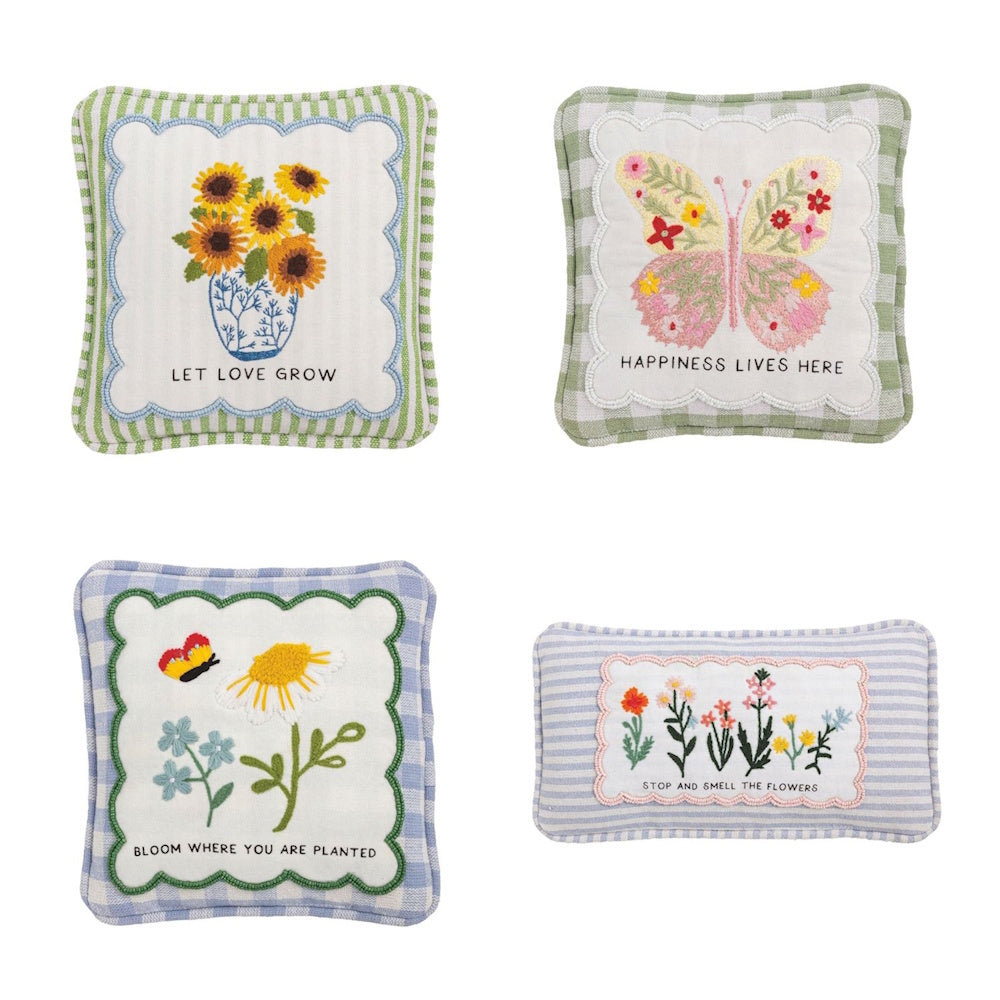 Set of four embroidered garden pillows with floral and butterfly designs and inspirational quotes on striped and gingham backgrounds.
