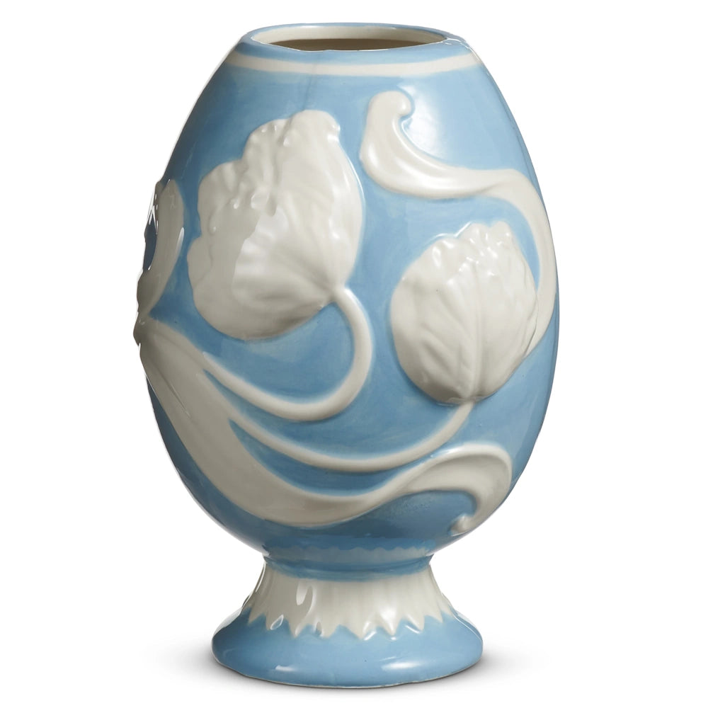 A blue and white vase with a rounded top and narrow base. It features raised, white floral designs, giving it an elegant and classic look.