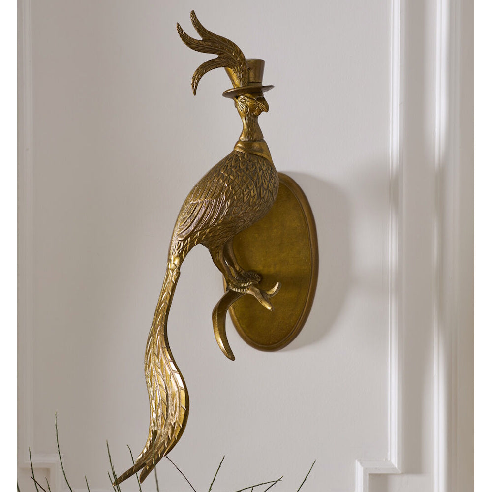 Vintage brass wall-mount sculpture of a bird wearing a top hat, perched on a branch.