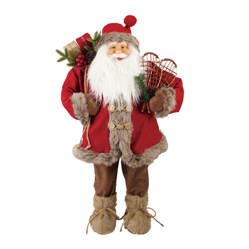 Fabric Santa figurine dressed in a red coat with faux fur trim, holding snowshoes and carrying a sack of gifts.