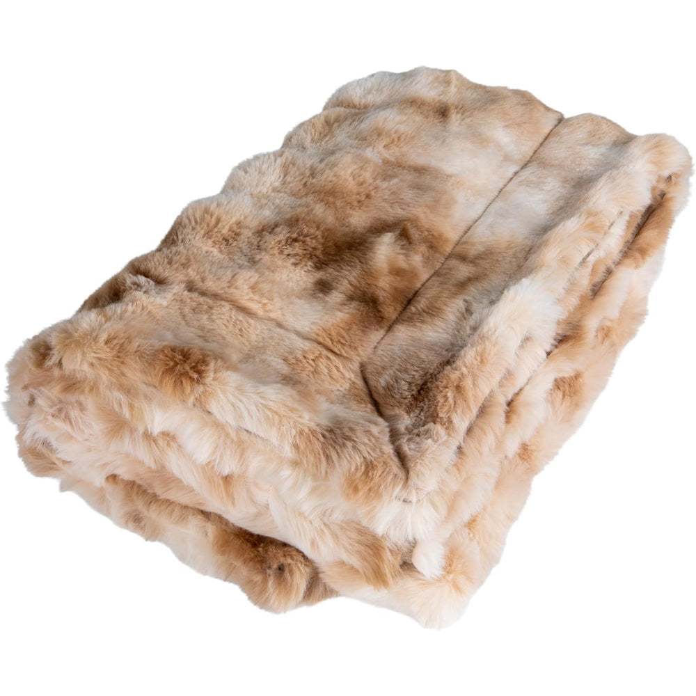 A luxuriously soft, tan and ivory channeled chinchilla faux fur throw blanket, folded and viewed at an angle on a white background.