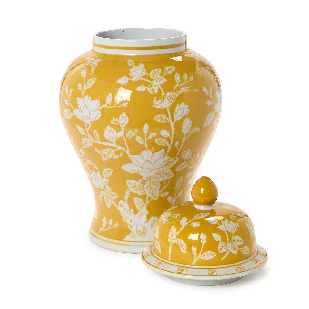Yellow ceramic temple jar with white floral pattern, open top, and matching lid beside it on a white background.