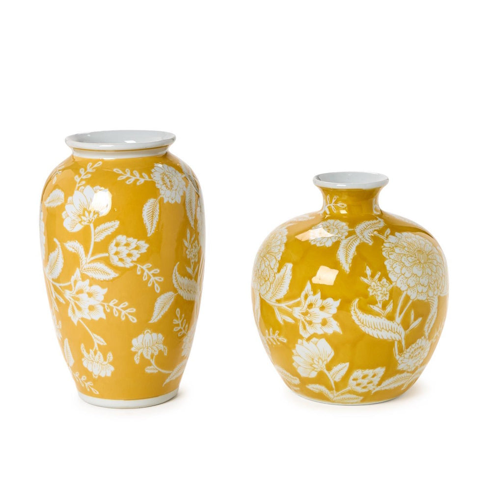 Two bright yellow ceramic vases with white floral patterns on a plain white background.