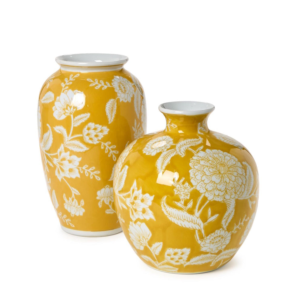Pair of bright yellow ceramic vases with intricate white floral patterns against a white background.