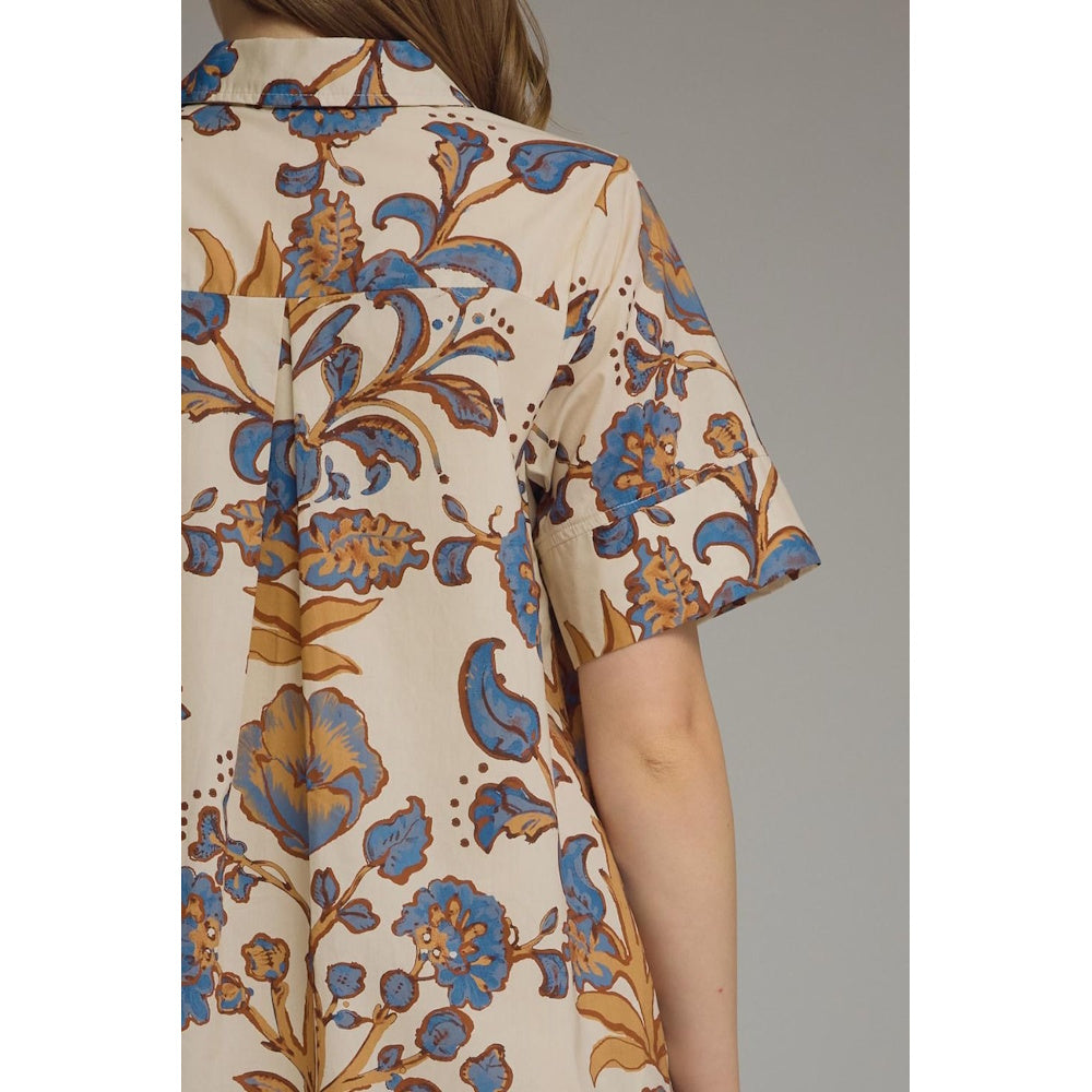 Close-up back view of a beige floral shirt dress, showing back yoke detail and short sleeve cuff.