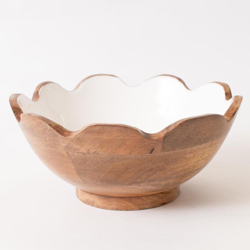 Fluted mango wood bowl with a scalloped rim and white enamel interior on a white background.
