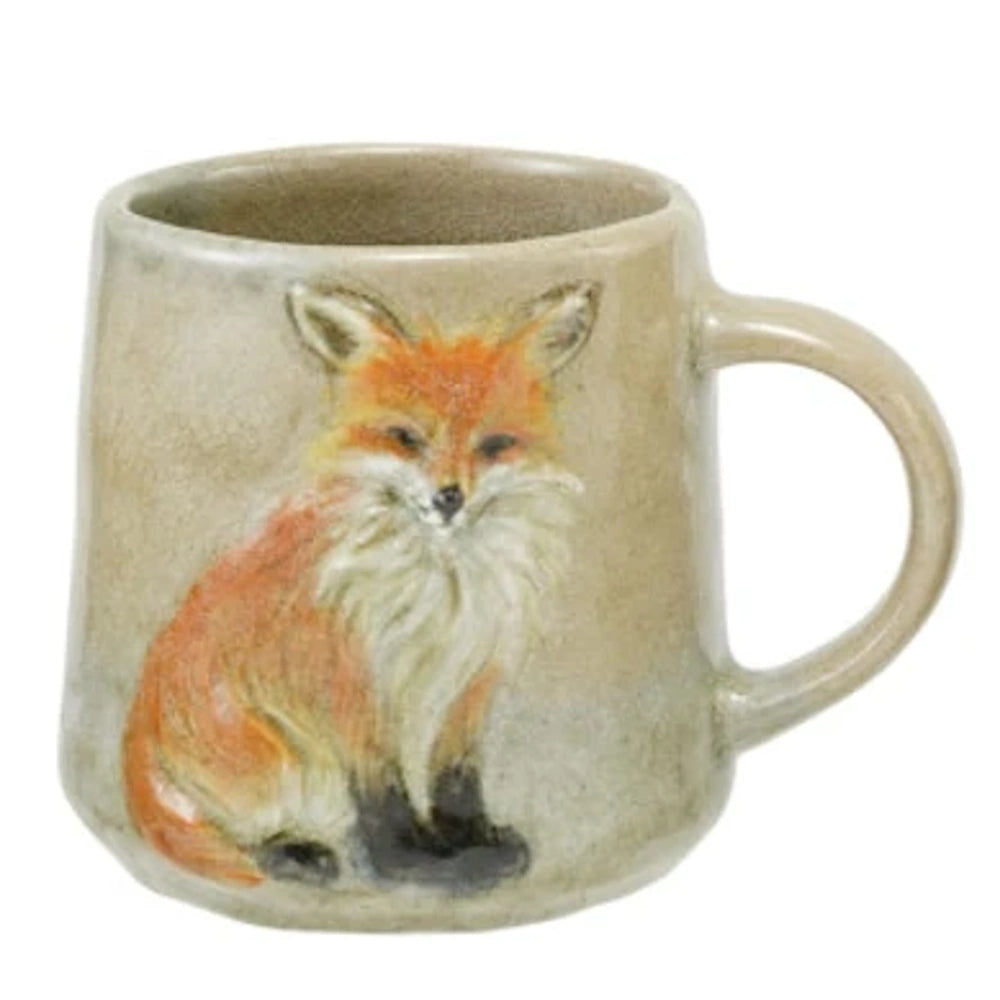 A ceramic mug featuring a detailed, hand-painted red fox embossed on its rustic beige stoneware surface.