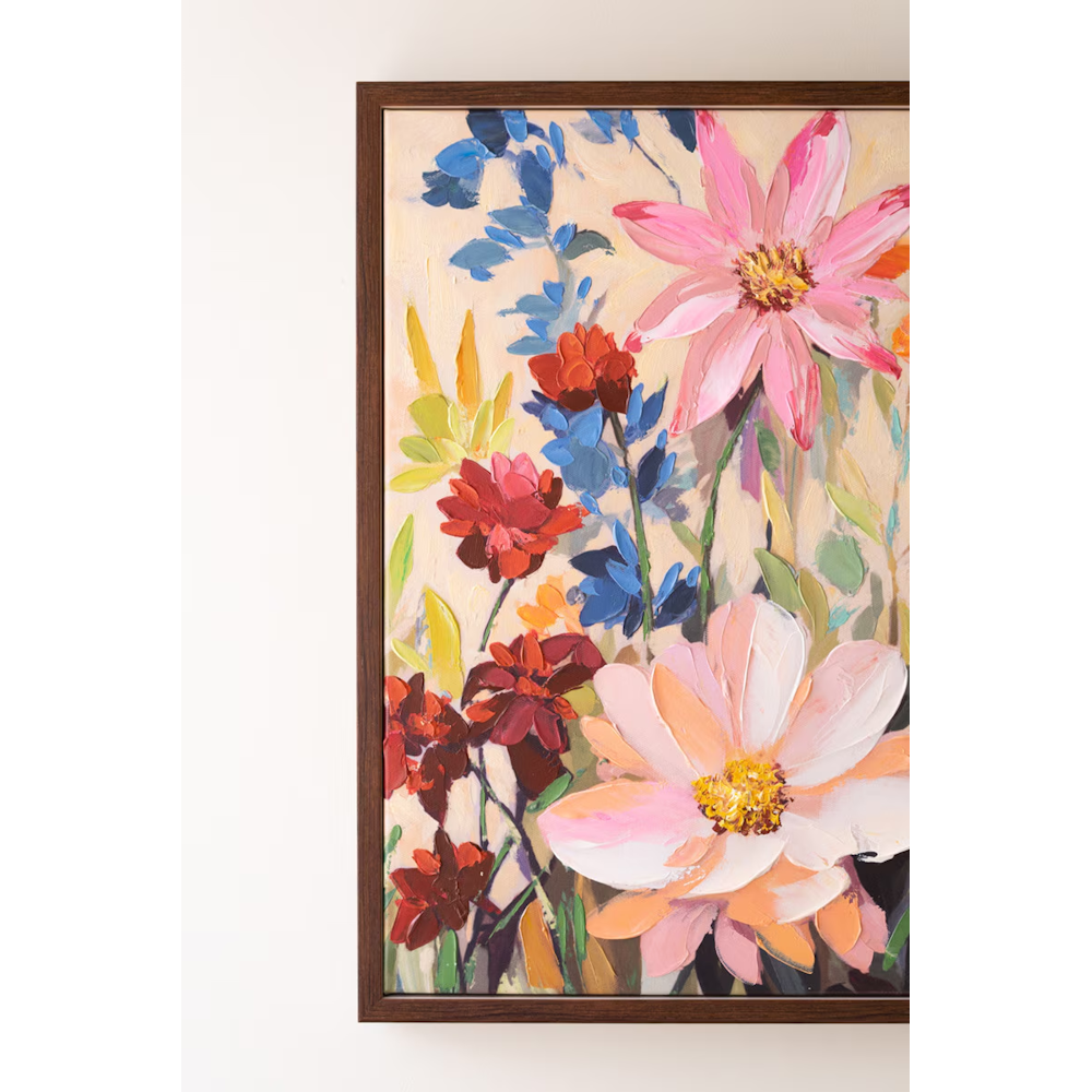 Close-up of vibrant pink and red painted flowers with dark wooden frame edge visible.