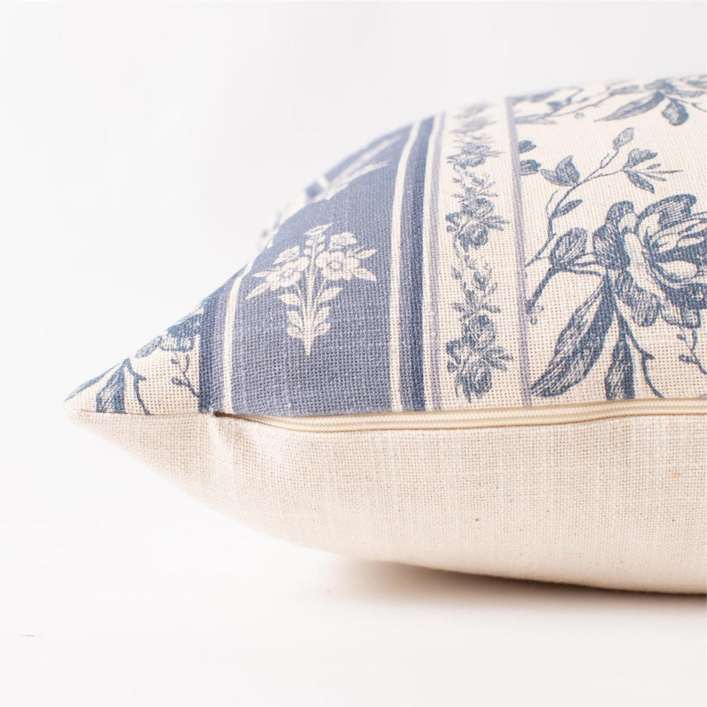 Blue and white French country floral lumbar pillow with hidden zipper detail on cream linen fabric.