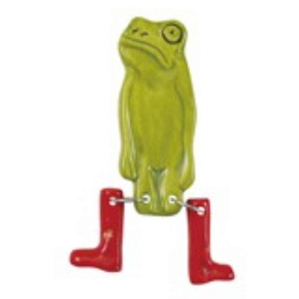 Green stoneware frog magnet with dangling red-booted legs against a white background.