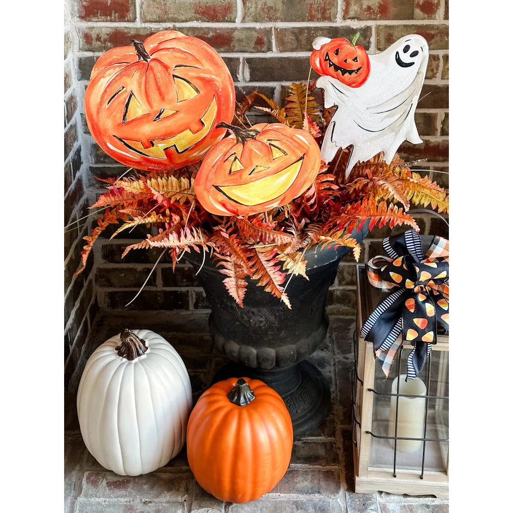 White metal back of a friendly ghost and pumpkin yard stake with an integrated hanging loop.