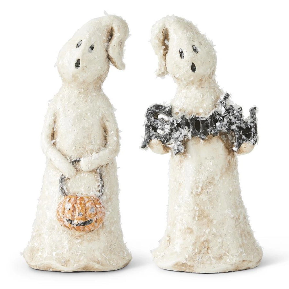 Two glittery white Halloween ghost figurines holding a pumpkin bucket and a black Spooky sign.