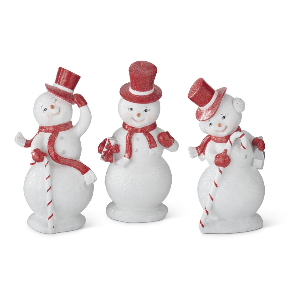 Front view of three white glittered resin snowmen wearing red top hats and scarves.