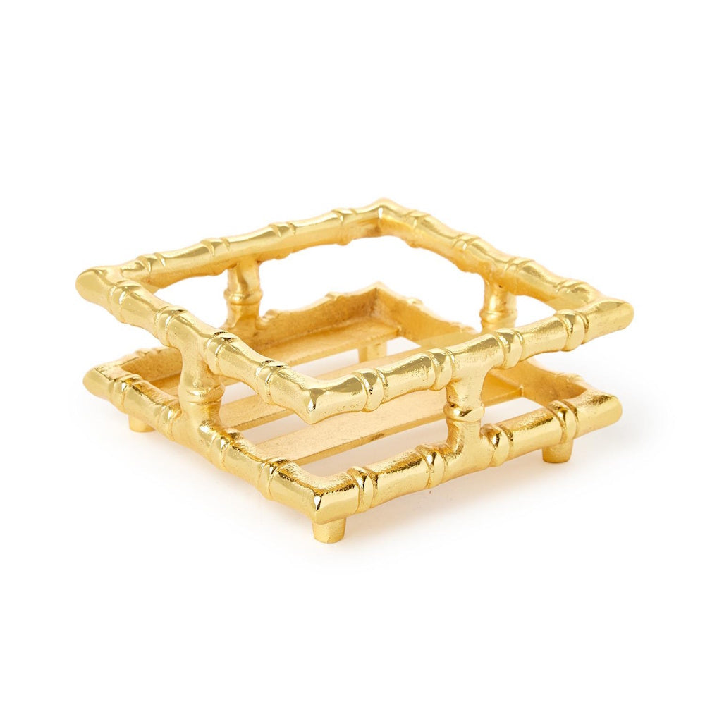 Gold metallic bamboo-style cocktail napkin holder with an open square frame design on a white background.