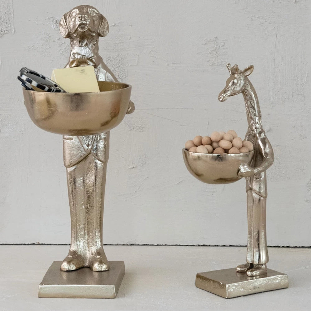 Set of two gold animal butler figurines, dog and giraffe, holding small decorative storage bowls on a white background.