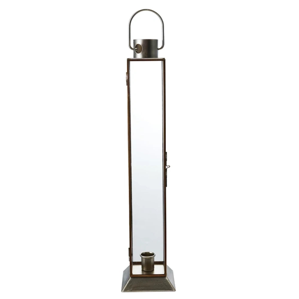 Tall rectangular gold finish metal and glass lantern with a top handle and internal taper candle holder.