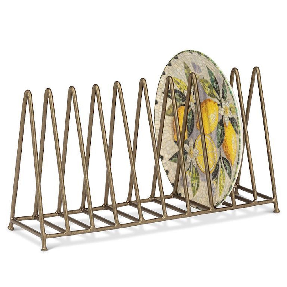 Gold wire plate rack holding a single round plate with a lemon pattern on white background.