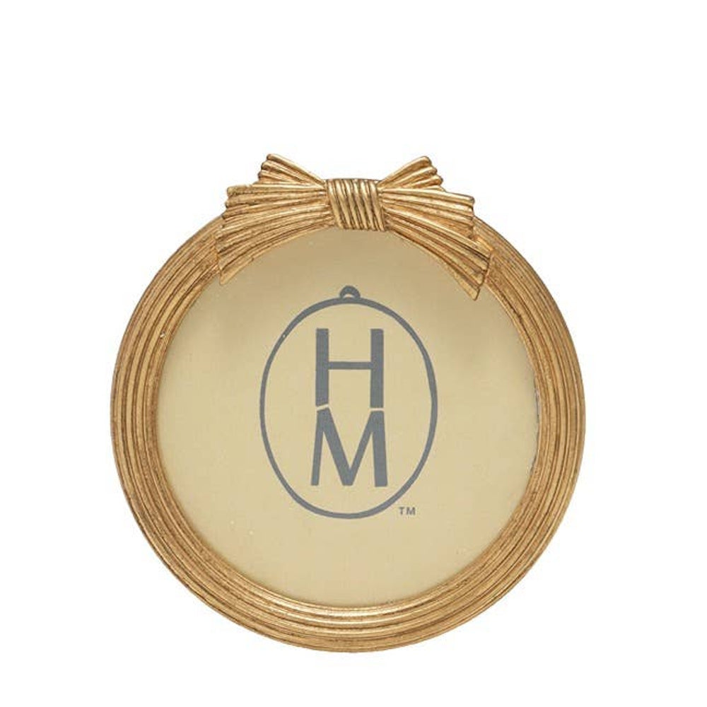 Round gold picture frame with textured ridges and a decorative bow embellishment at the top.
