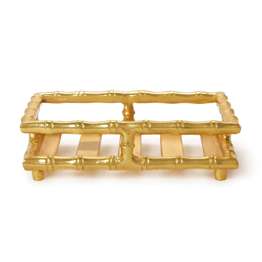 Rectangular gold bamboo-style napkin or guest towel holder tray on a plain white background.