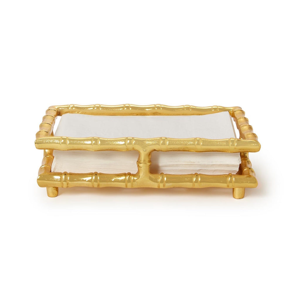 A gold bamboo-style guest towel napkin holder tray filled with white napkins, centered against a plain white background.