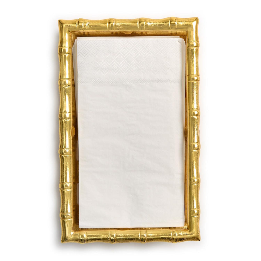 Top-down view of a rectangular gold bamboo guest towel napkin holder filled with folded white paper napkins.