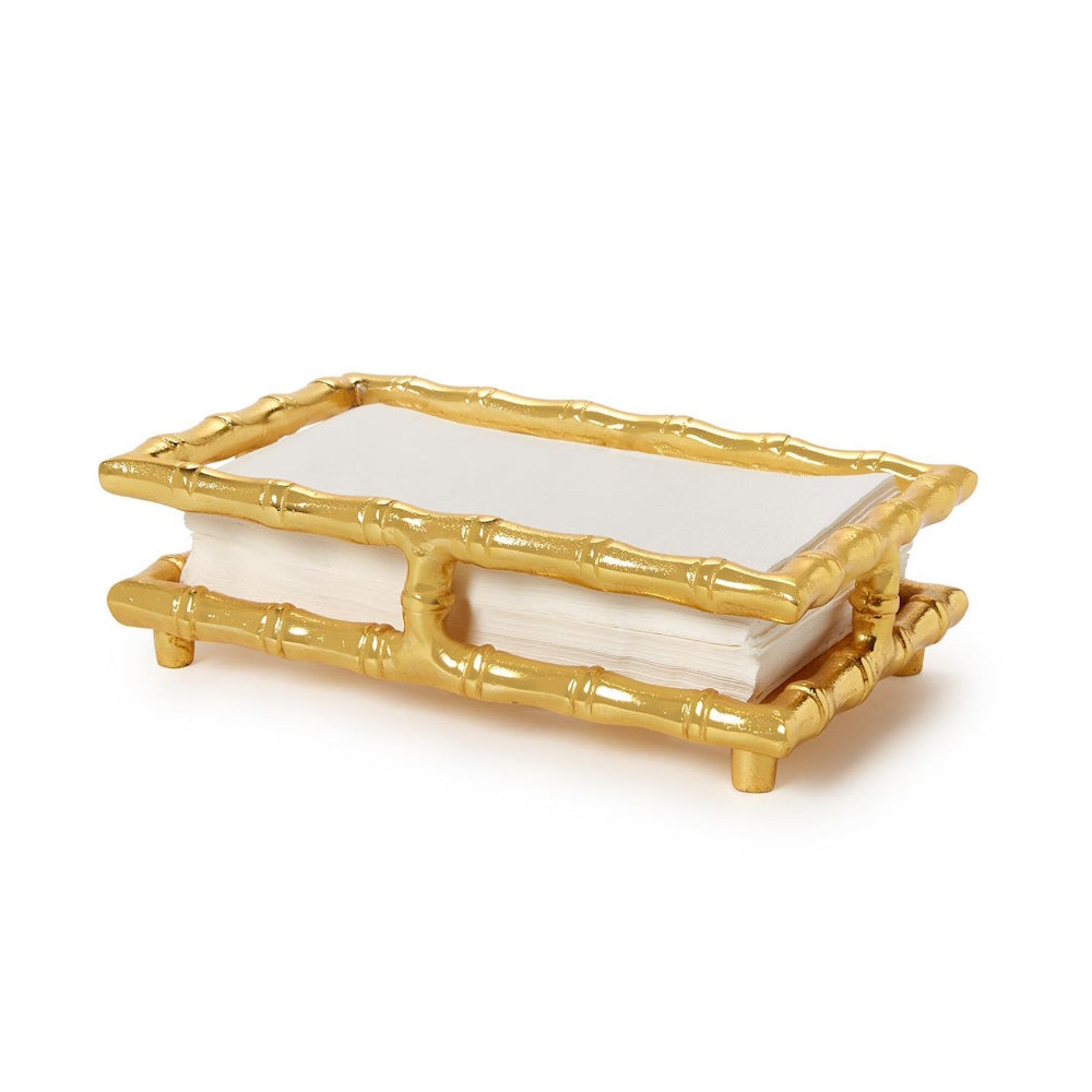 Rectangular gold faux bamboo guest towel napkin holder holding white paper napkins on a white background.