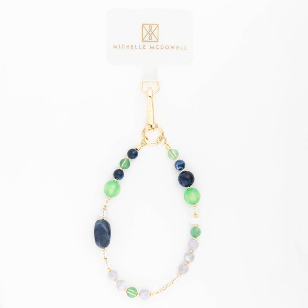Green and blue beaded phone charm strap with gold hardware on a plain white background.