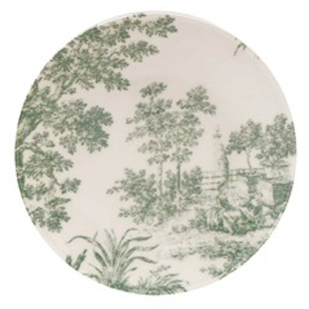 A round stoneware plate featuring a green toile landscape with lush trees and a stone wall.
