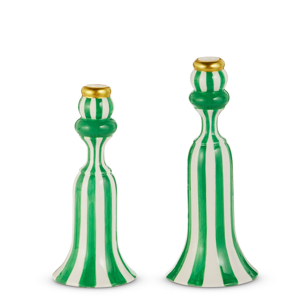 Two green and white striped ceramic candlesticks, adorned with golden tops. One is taller, creating a playful and elegant contrast.