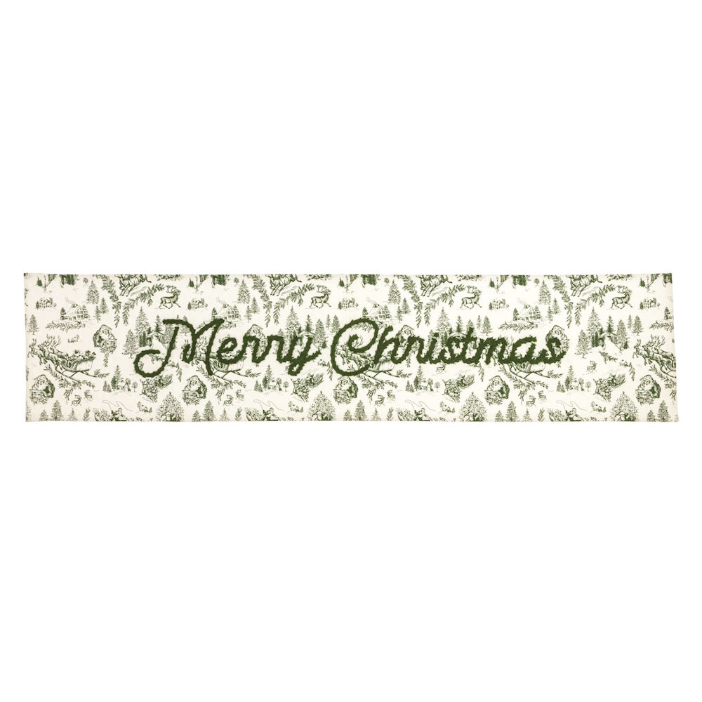 White table runner with green toile holiday print and "Merry Christmas" script center.