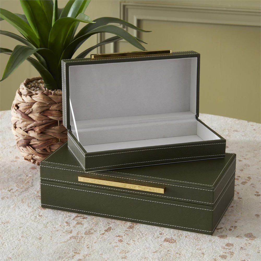 Green vegan leather nesting boxes with gold hardware and white felt lining.