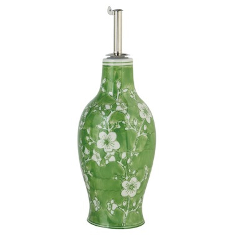 Green hand-painted stoneware oil cruet with a white floral blossom pattern and a stainless steel pour spout.