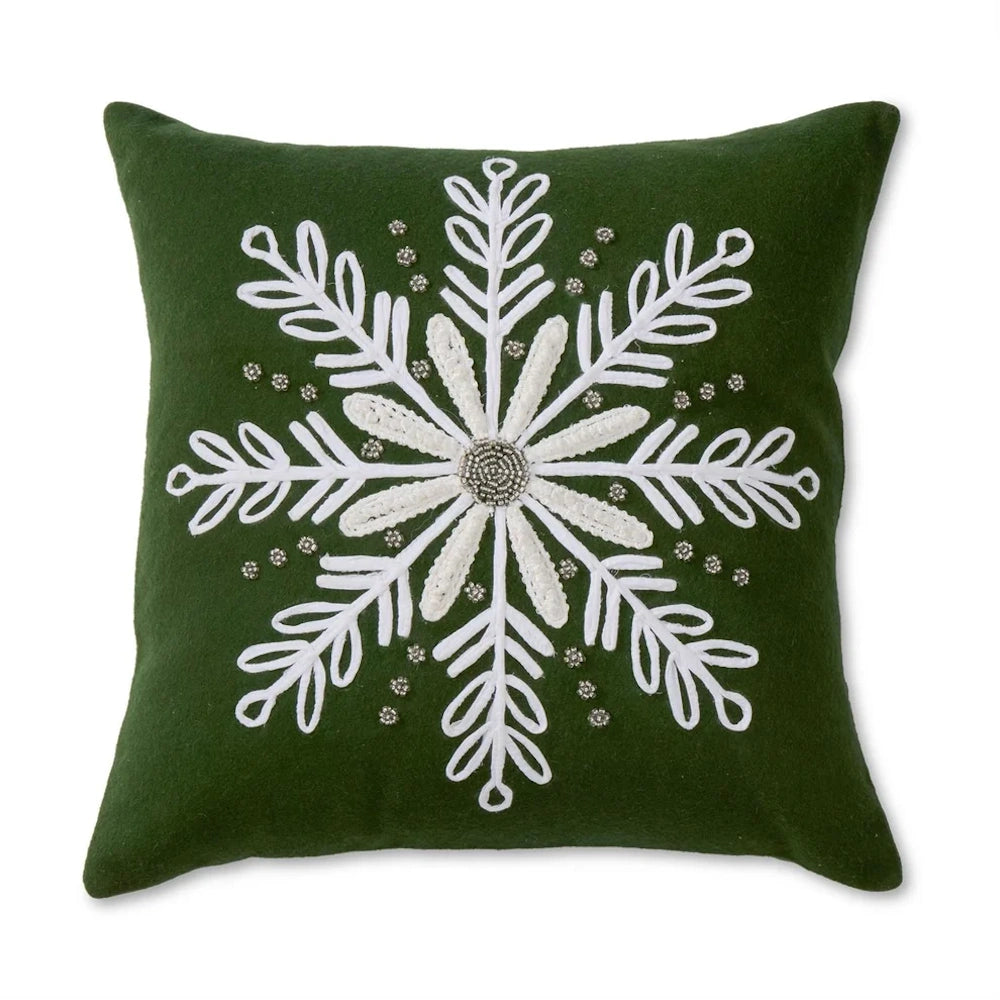 Front view of a green wool pillow with a white beaded snowflake applique.